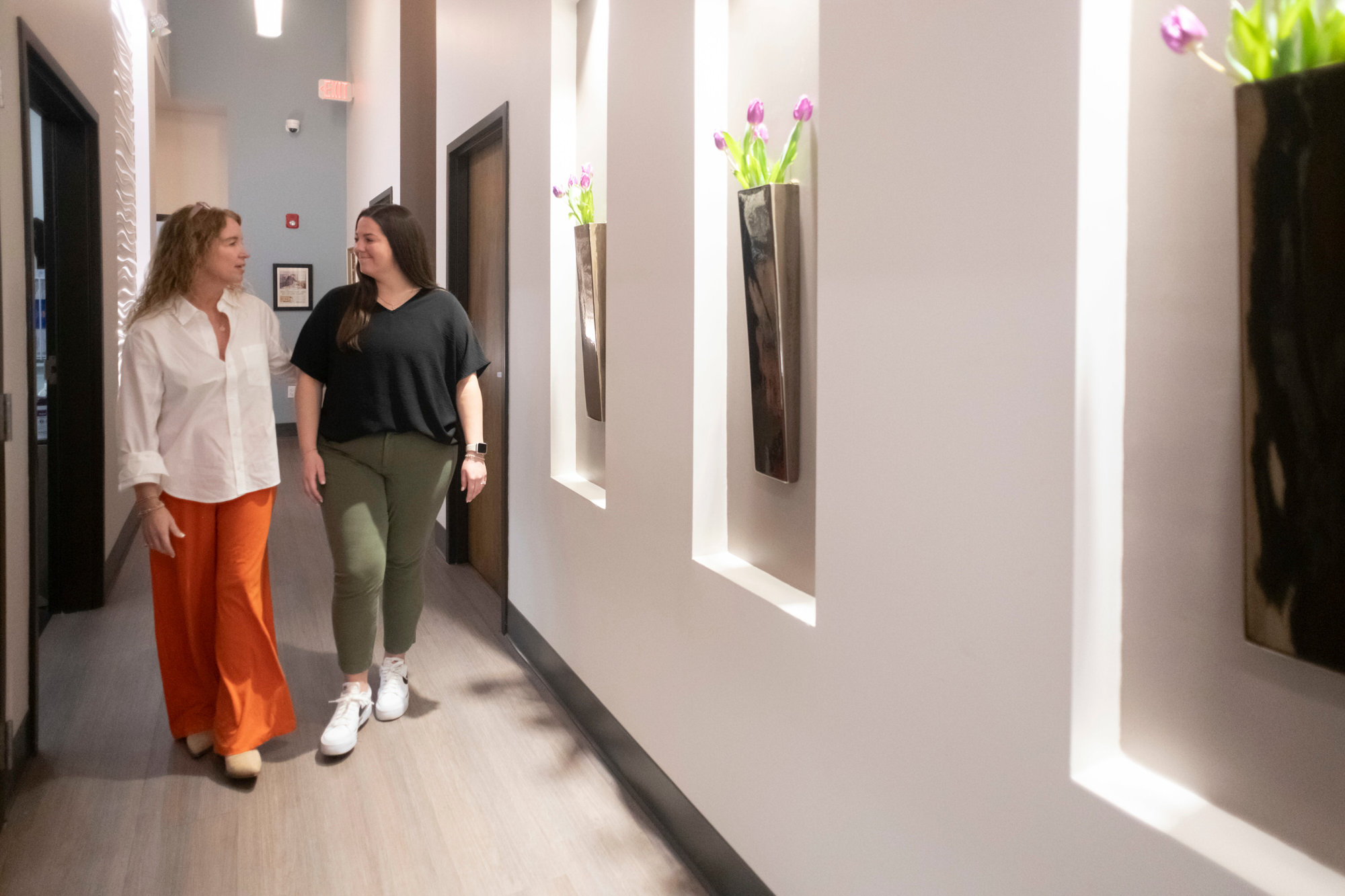 Hallway with tulips, wavy wall, and patient room with zero-gravity recliner