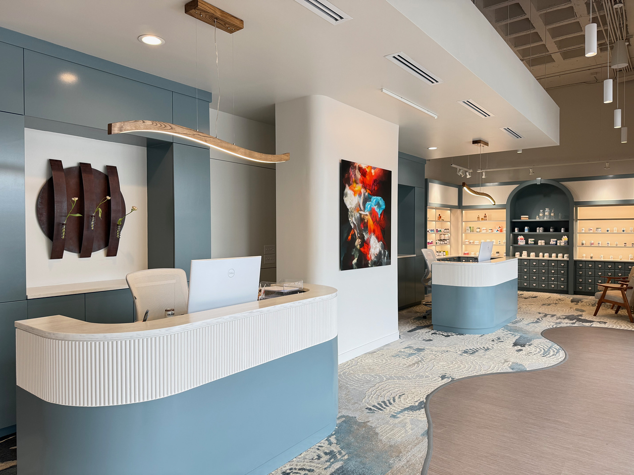 Reception area with art wall, sculpture, and reading nook