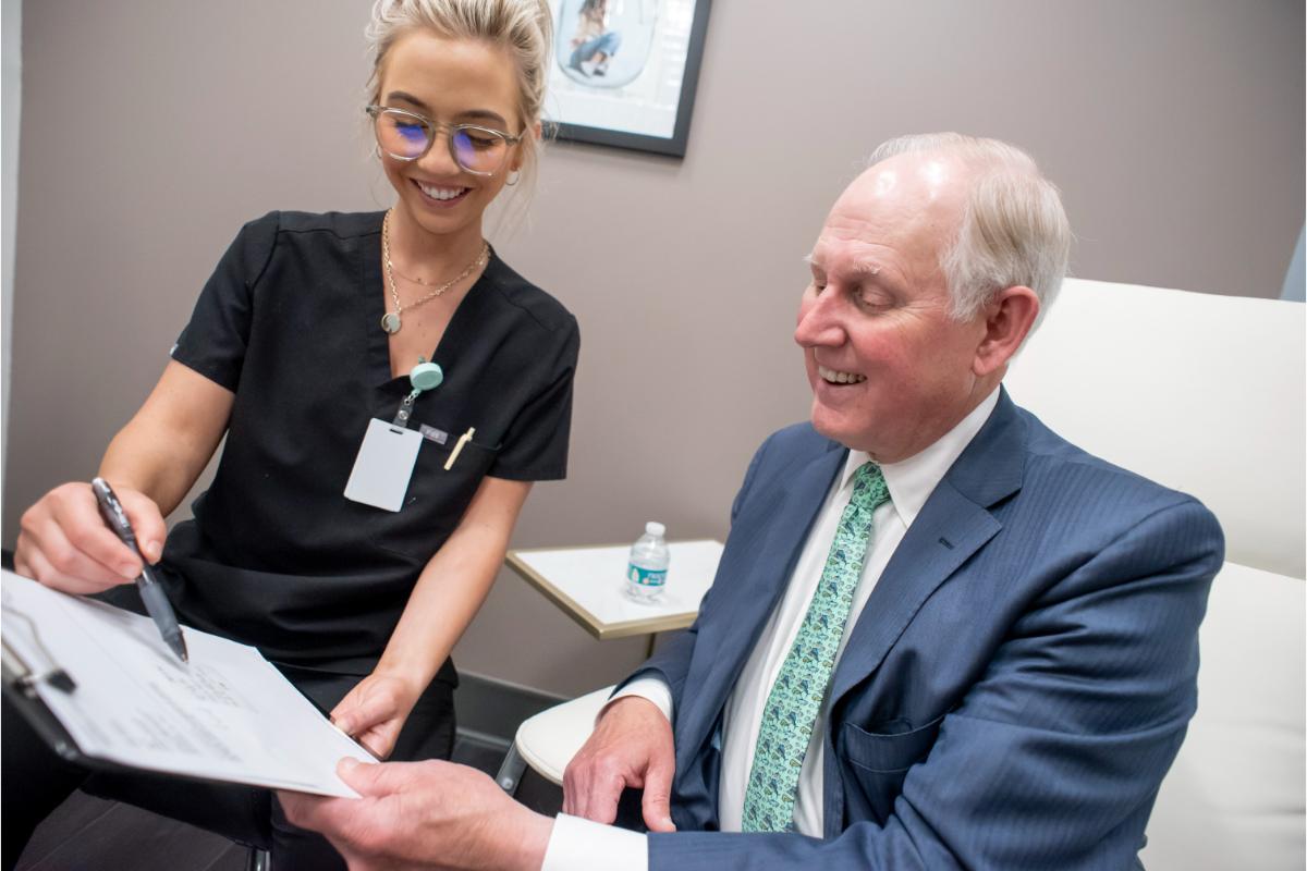 Staff member reviewing costs with a patient before treatment